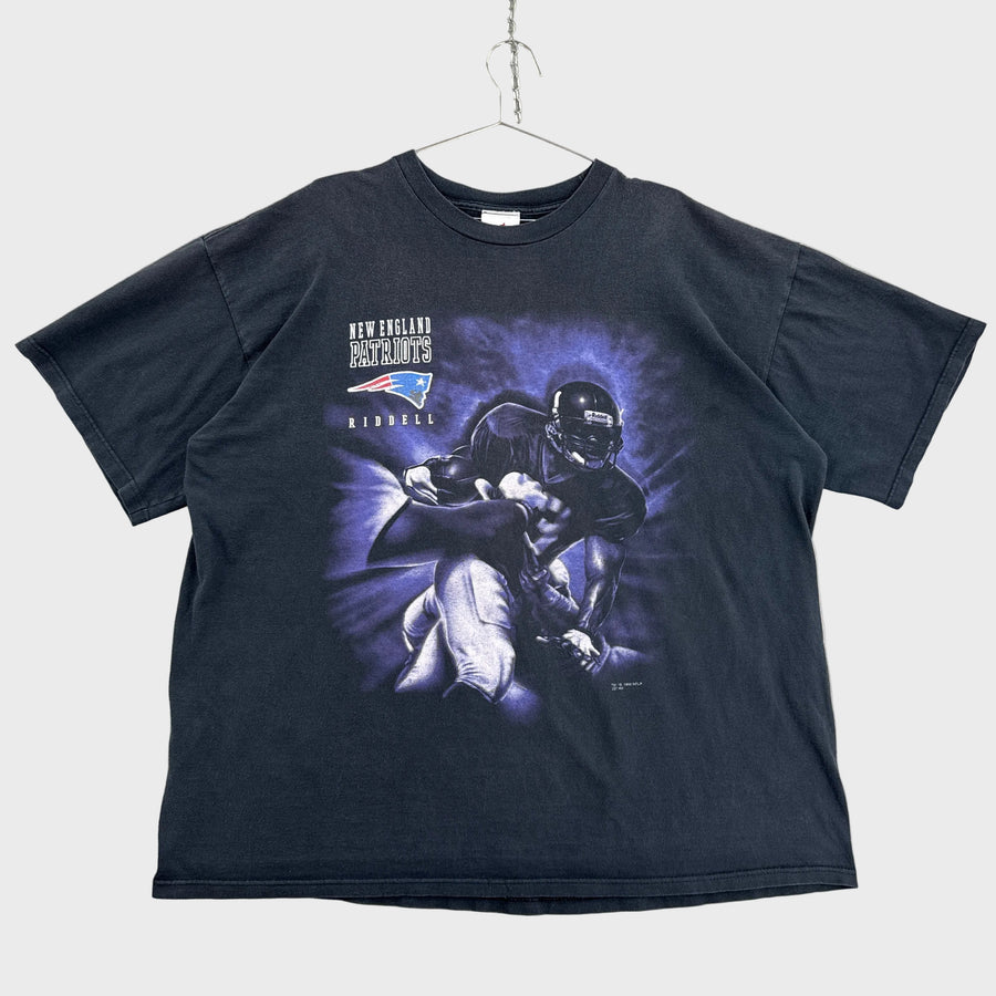 Black t-shirt with graphic design on a gray surface