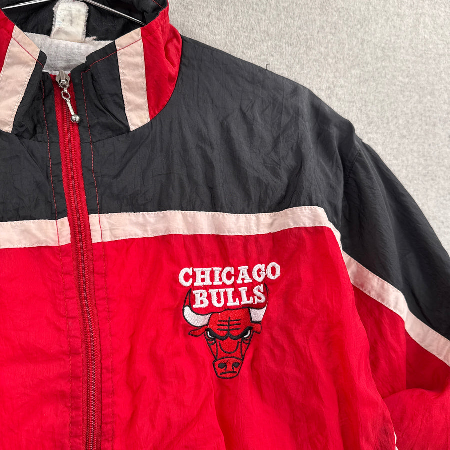 Red and black jacket with Chicago Bulls logo on a gray background