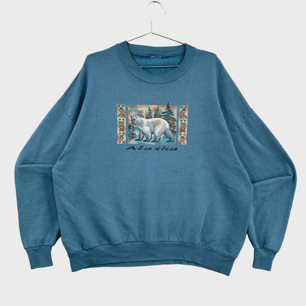 Blue sweatshirt with a polar bear bear graphic and 'Alaska' text on a beige background