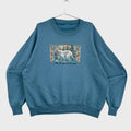 Blue sweatshirt with a polar bear bear graphic and 'Alaska' text on a beige background