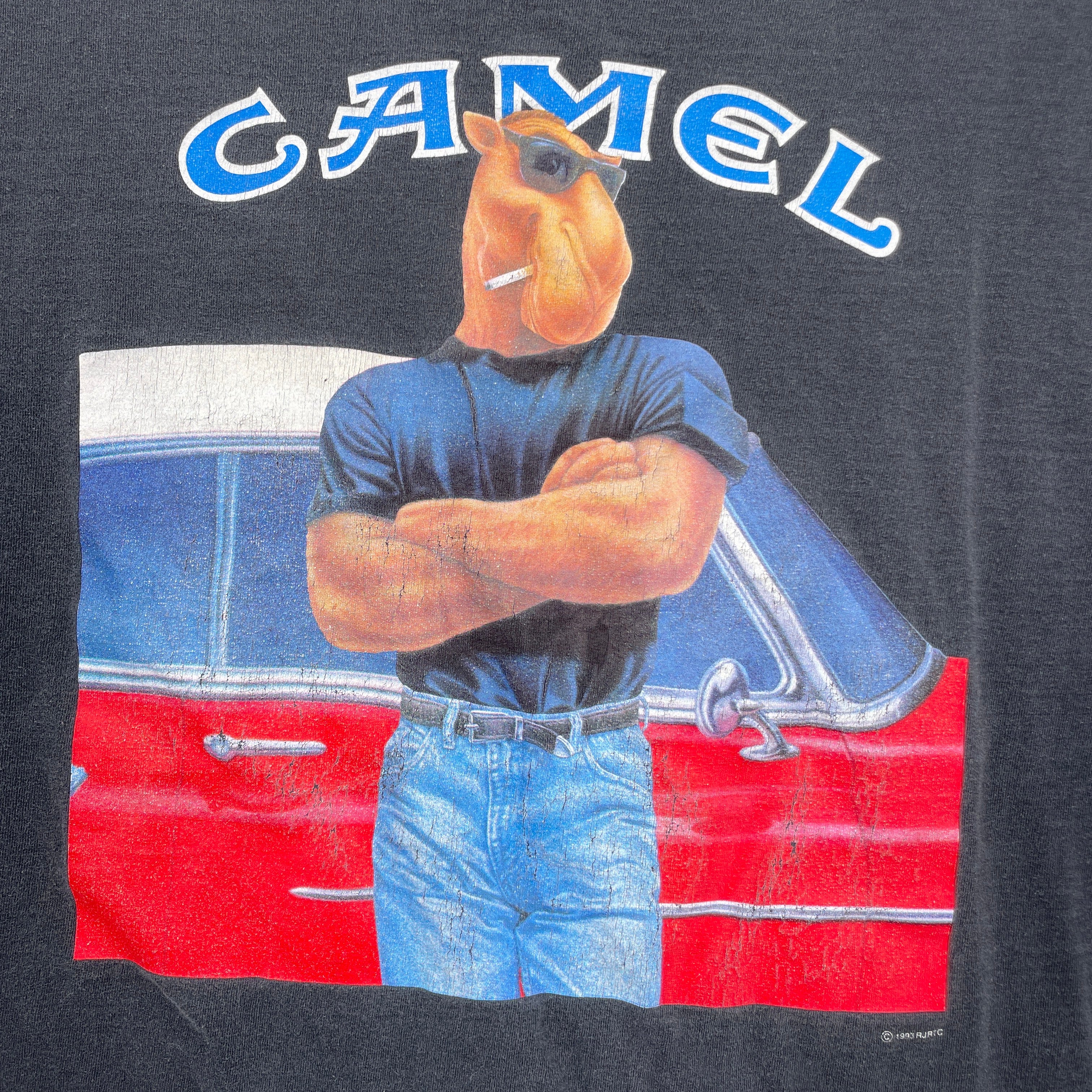 Camel brand logo with a camel character standing next to a red car on a dark background
