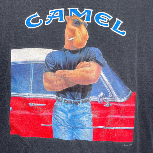 Camel brand logo with a camel character standing next to a red car on a dark background