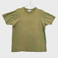 Green t-shirt on a hanger against a neutral background