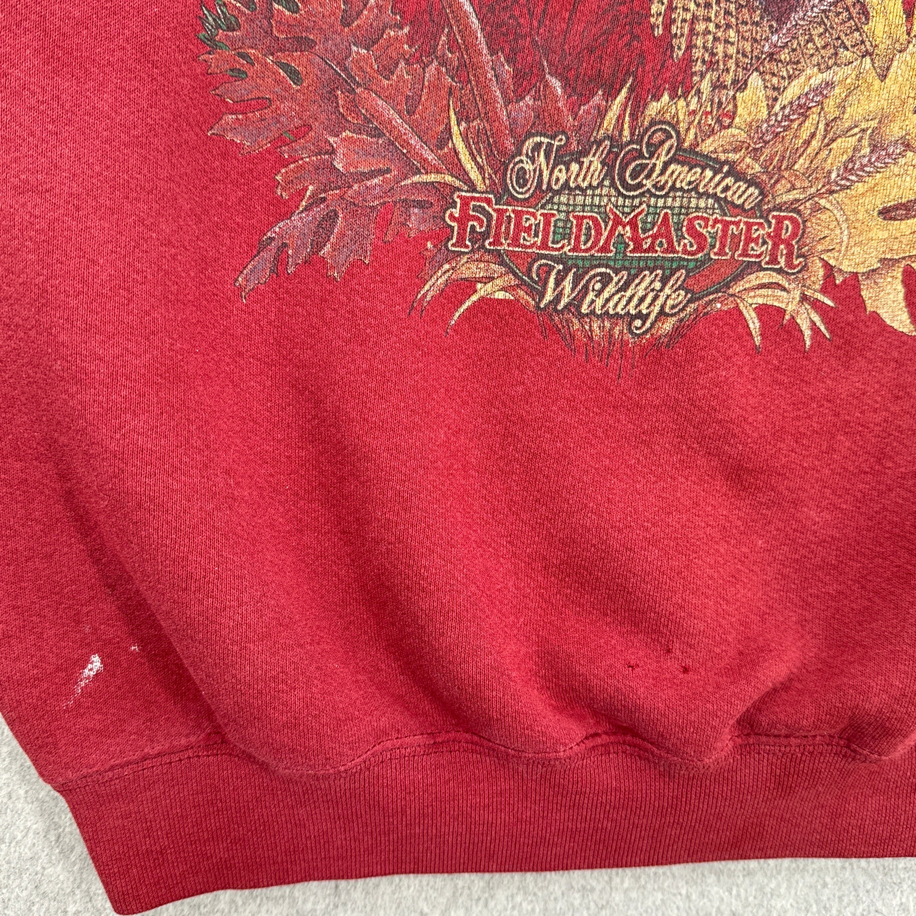 bottom of sweatshirt showing some stain spots and holes