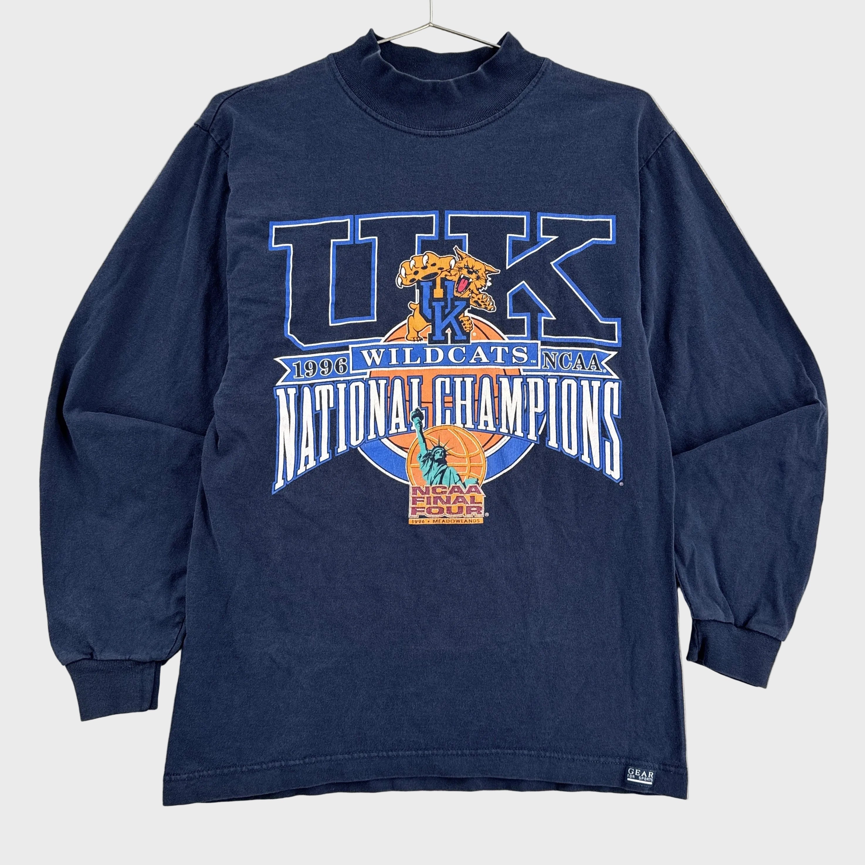 Navy long-sleeve shirt with 'UK Wildcats National Champions' graphic on a beige background