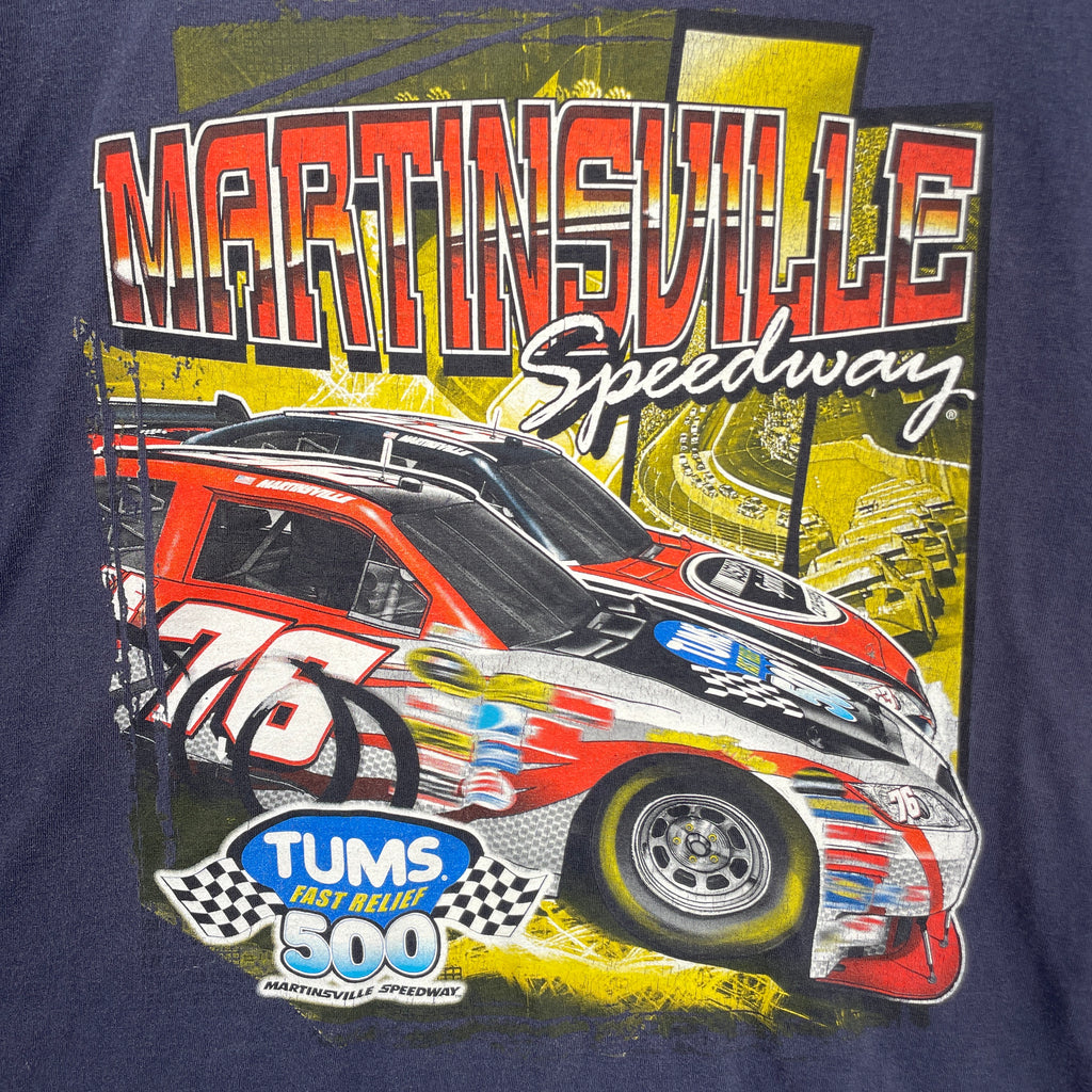 Navy blue t-shirt with a colorful race car graphic and text on a dark background. Martinsville Speedway with a racecar sponsored by Tums fast relief