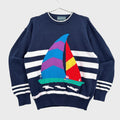 Navy sweater with colorful sailboat design on a gray background