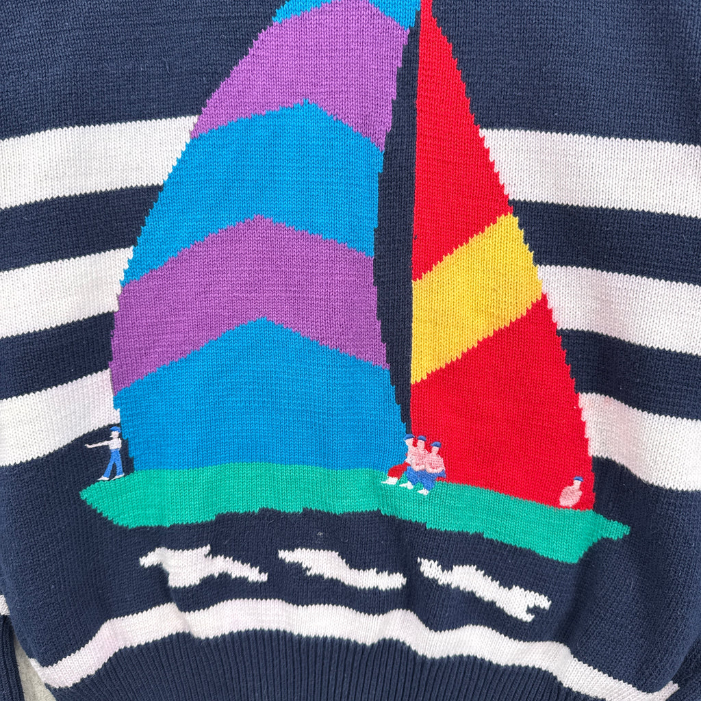 Colorful geometric pattern of a sailboat on a striped sweater