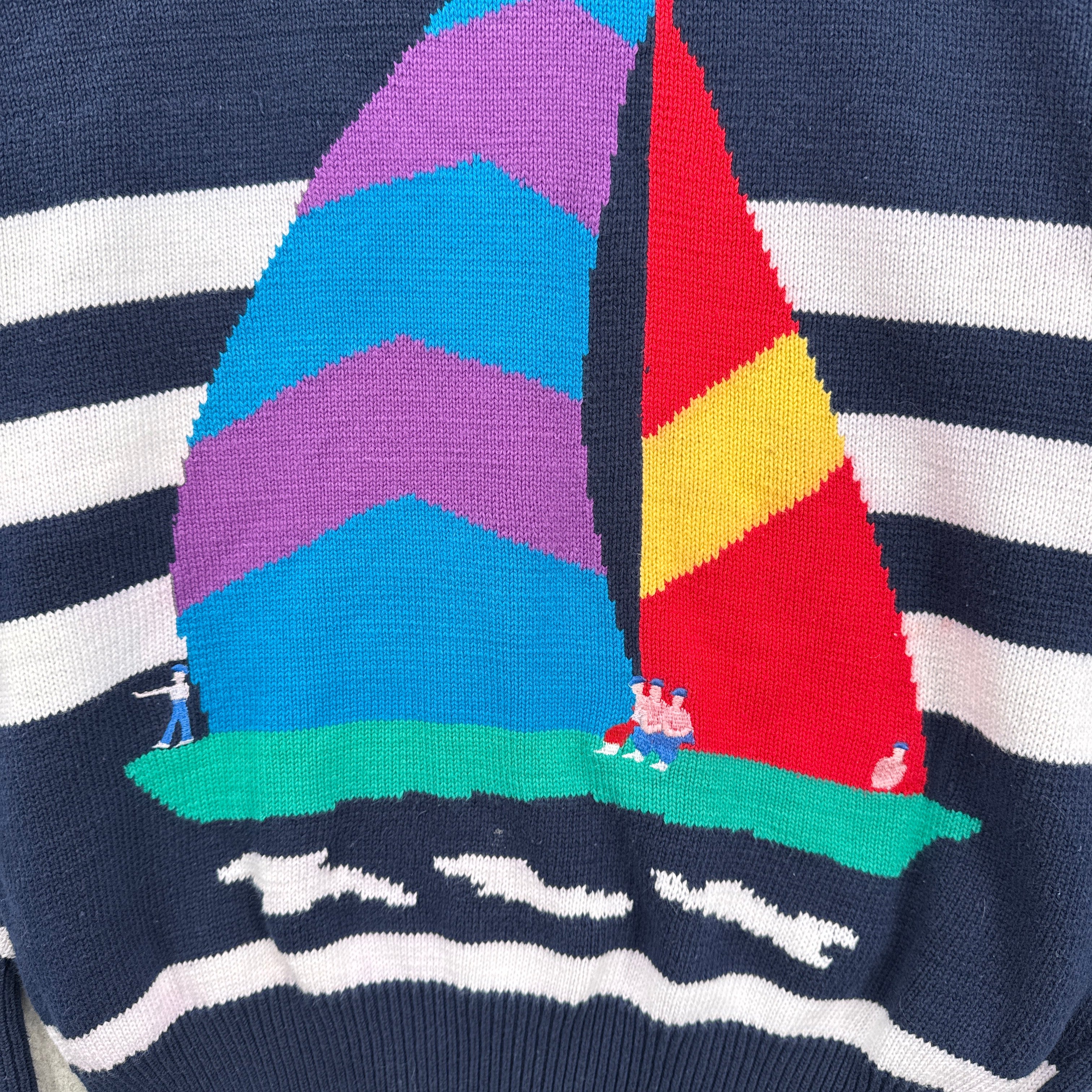 Colorful geometric pattern of a sailboat on a striped sweater