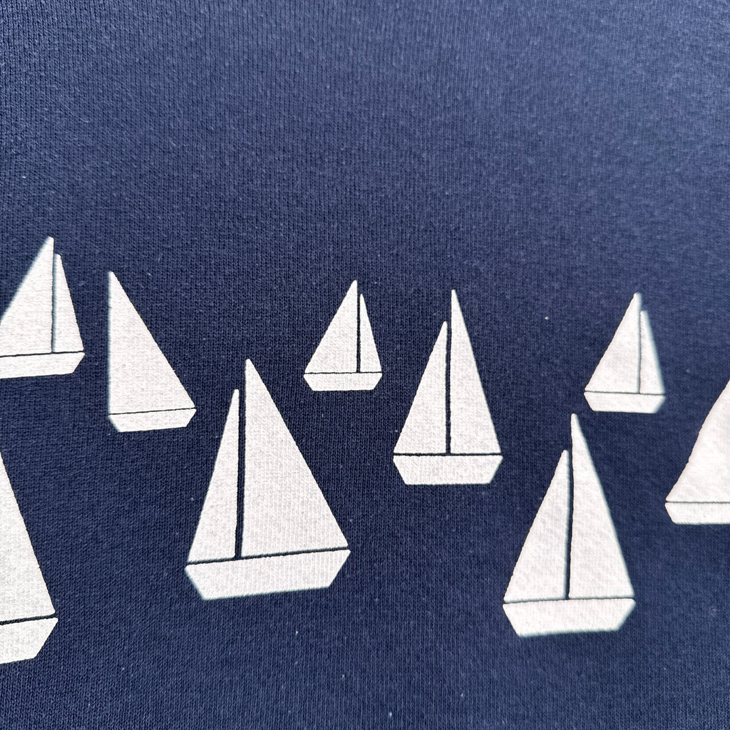 White sailboats on a blue background