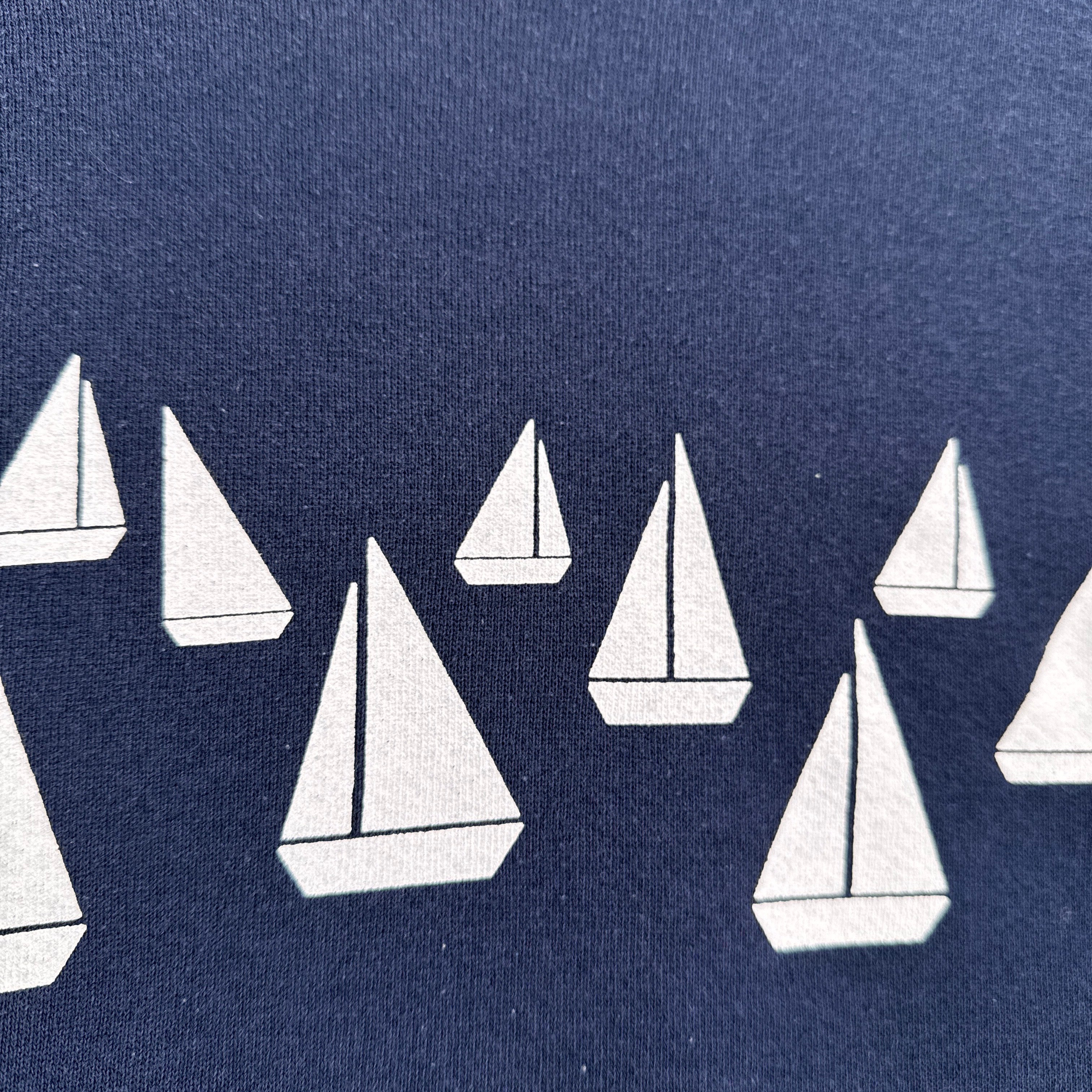 White sailboats on a blue background