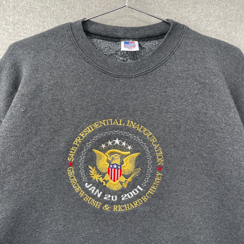 Gray sweatshirt with presidential inauguration emblem on a hanger