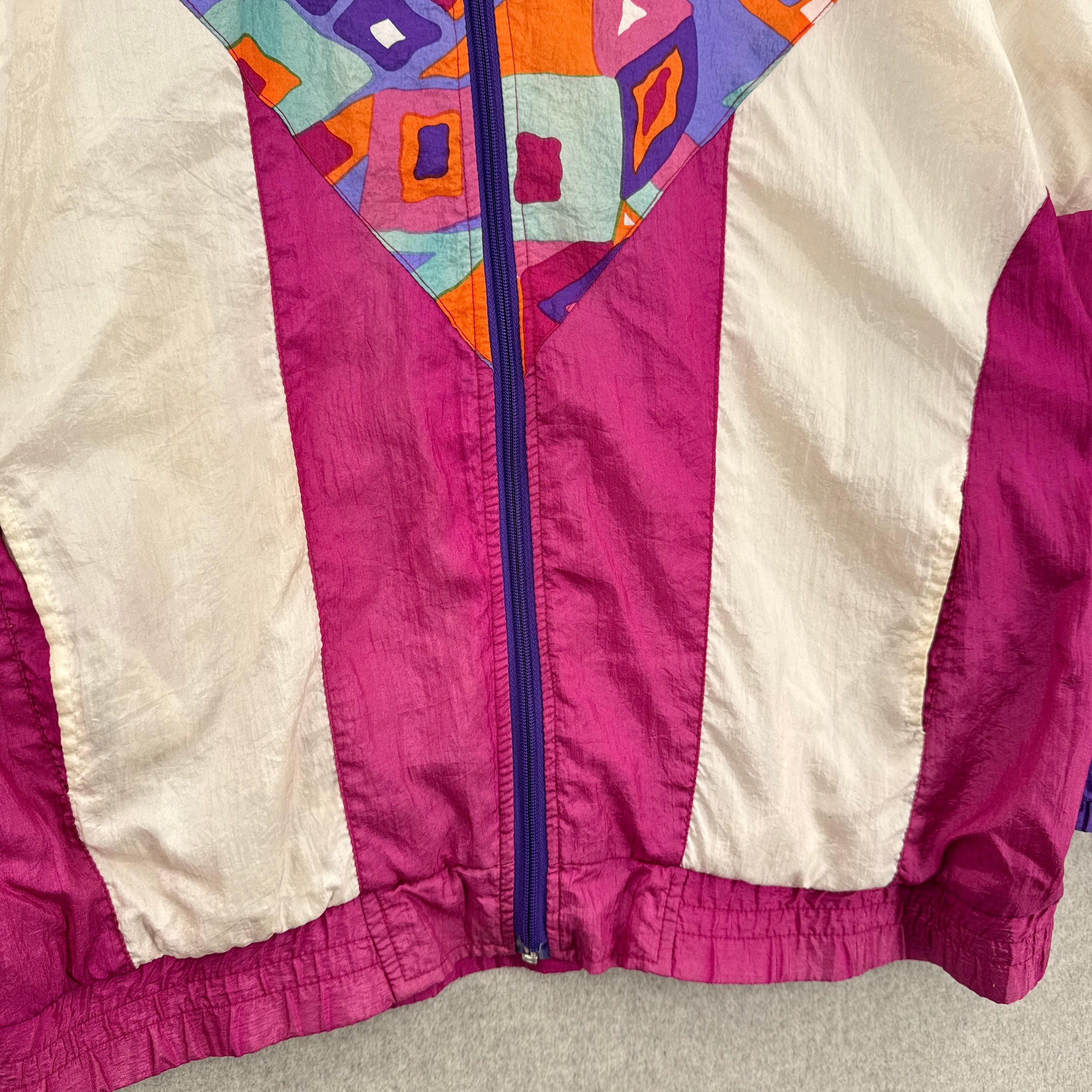 Close-up of a colorful jacket with geometric patterns on a neutral background