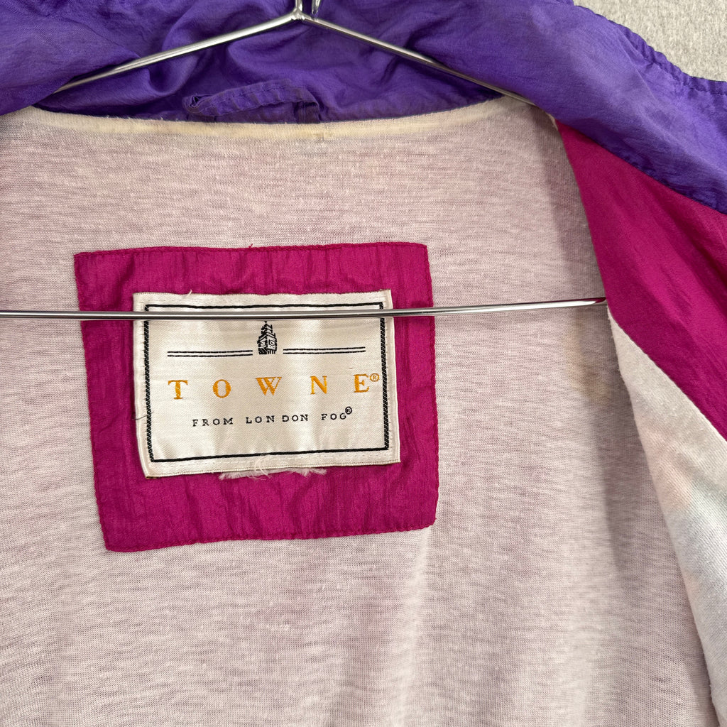 Close-up of a label on a piece of fabric with purple and gray colors. Towne by London Fog brand
