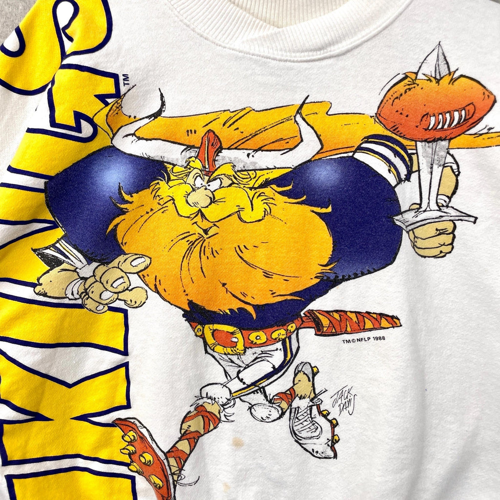 Cartoon character holding a football and trophy on a sports-themed shirt