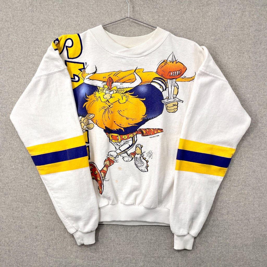 White sweatshirt with a cartoon character design on a gray background