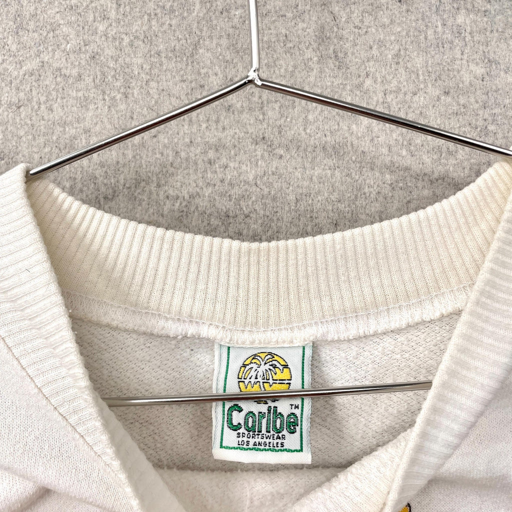 White sweater with a visible brand label on a hanger