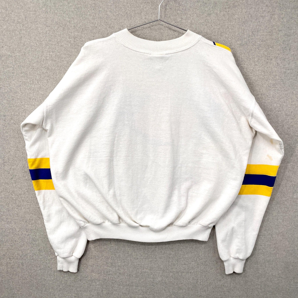 White sweatshirt with yellow and blue stripes on sleeves against a gray background