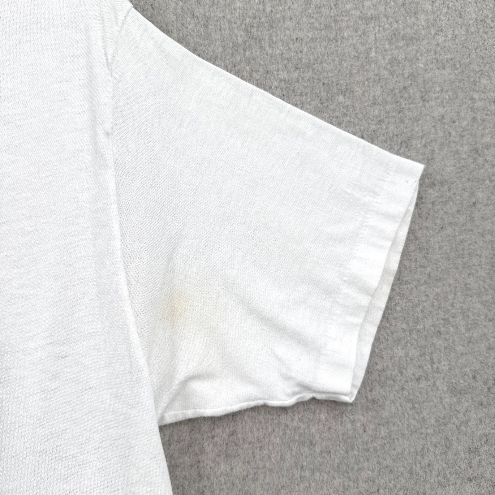 White fabric with a stain on a gray background
