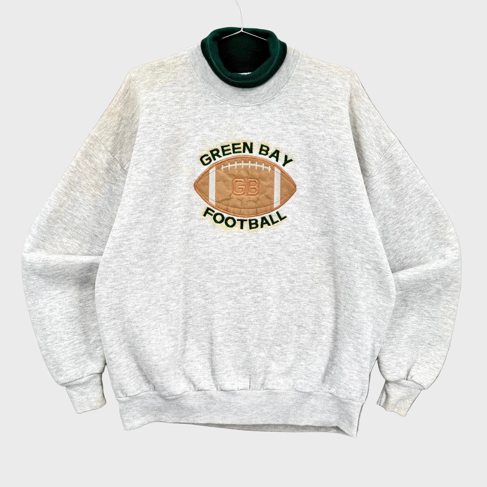 Gray sweatshirt with Green Bay Football logo on a gray background