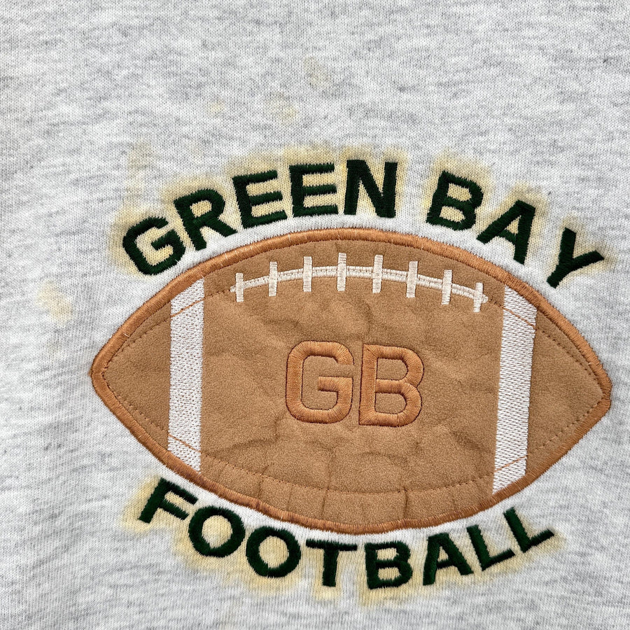 Embroidered Green Bay football design on a gray fabric background