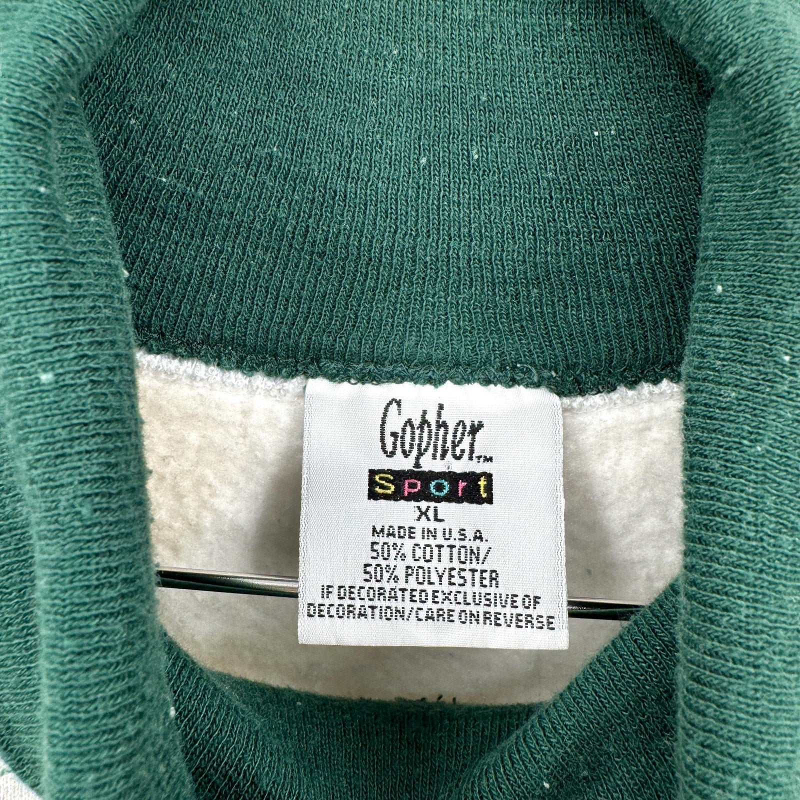 Green sweater with a Gopher Sport label on a white background