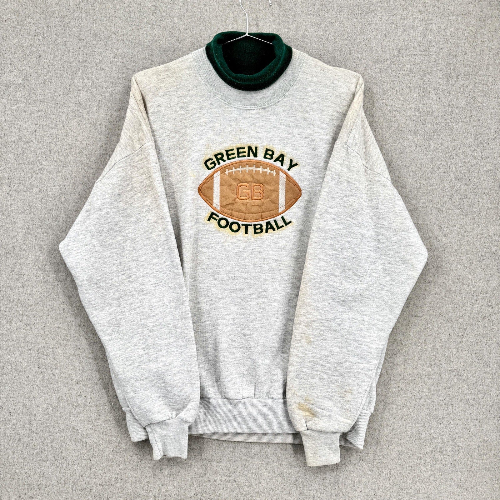 Gray sweatshirt with 'Green Bay Football' logo on a gray background