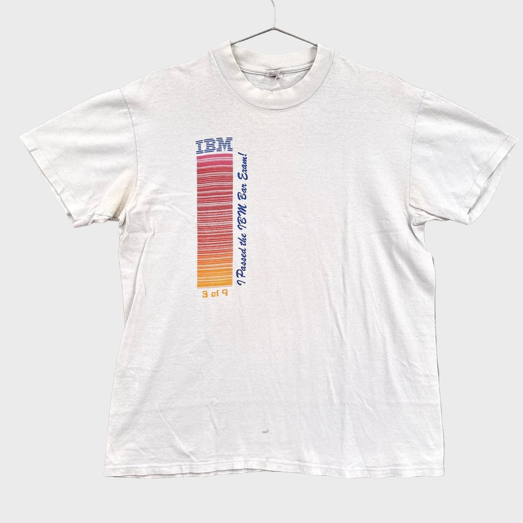 White t-shirt with IBM logo and text on a gray background
