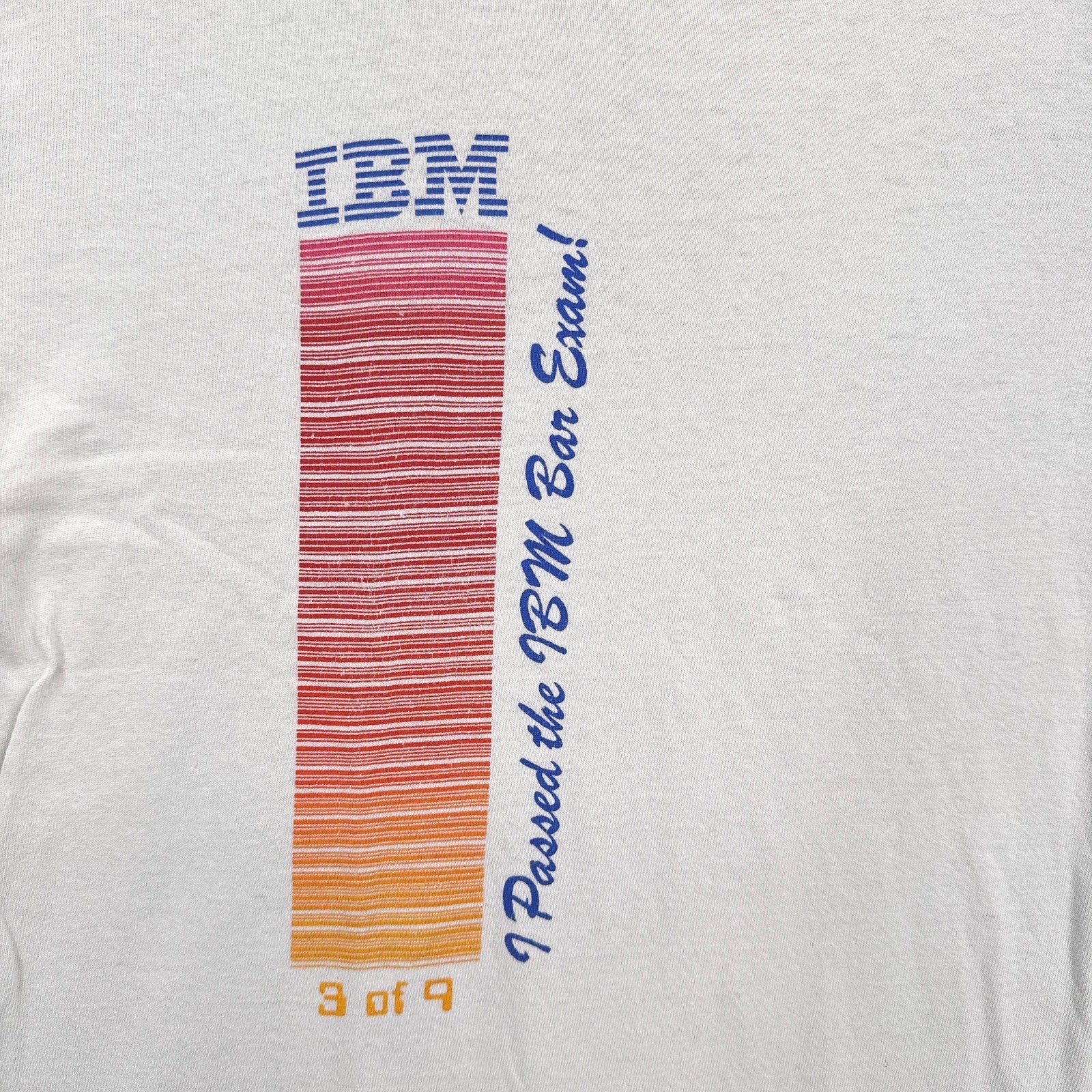 White t-shirt with IBM logo and text on a white background