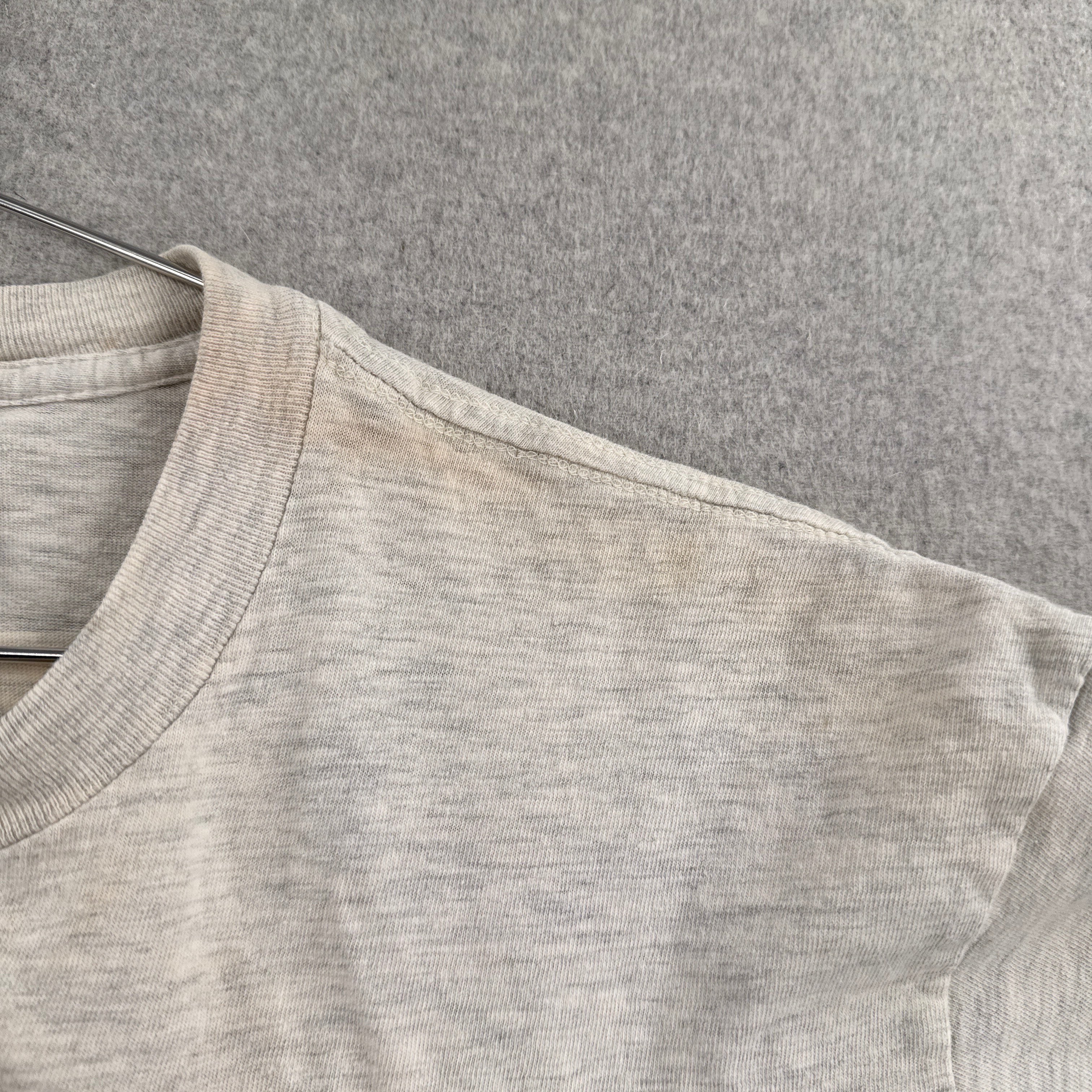 Close-up of a gray fabric texture with a focus on the material and color. discolouration around the collar