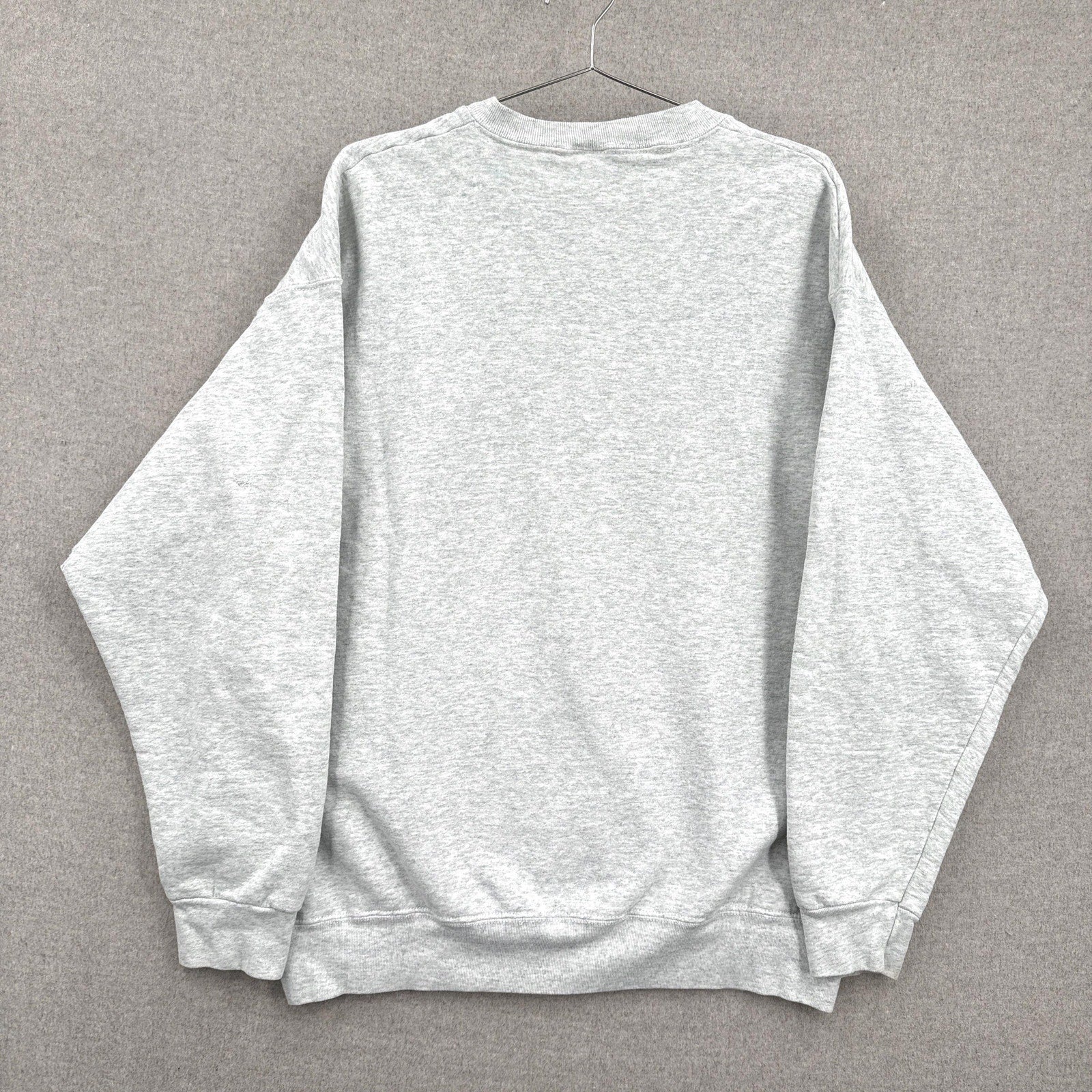 Gray sweatshirt on a hanger against a gray background