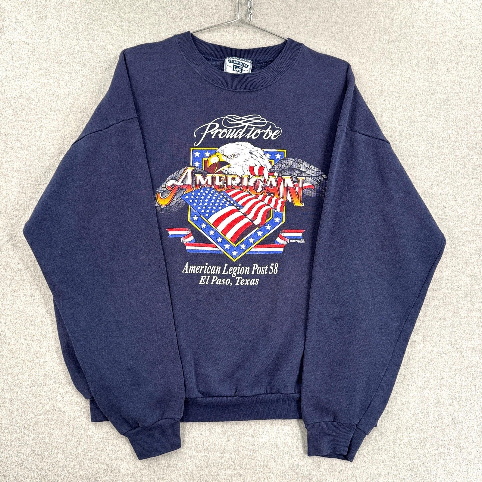 Navy blue sweatshirt with American-themed graphic on a light gray background