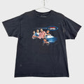 Black t-shirt with graphic design of a boy band NSYNC, hanging on a gray textured surface.