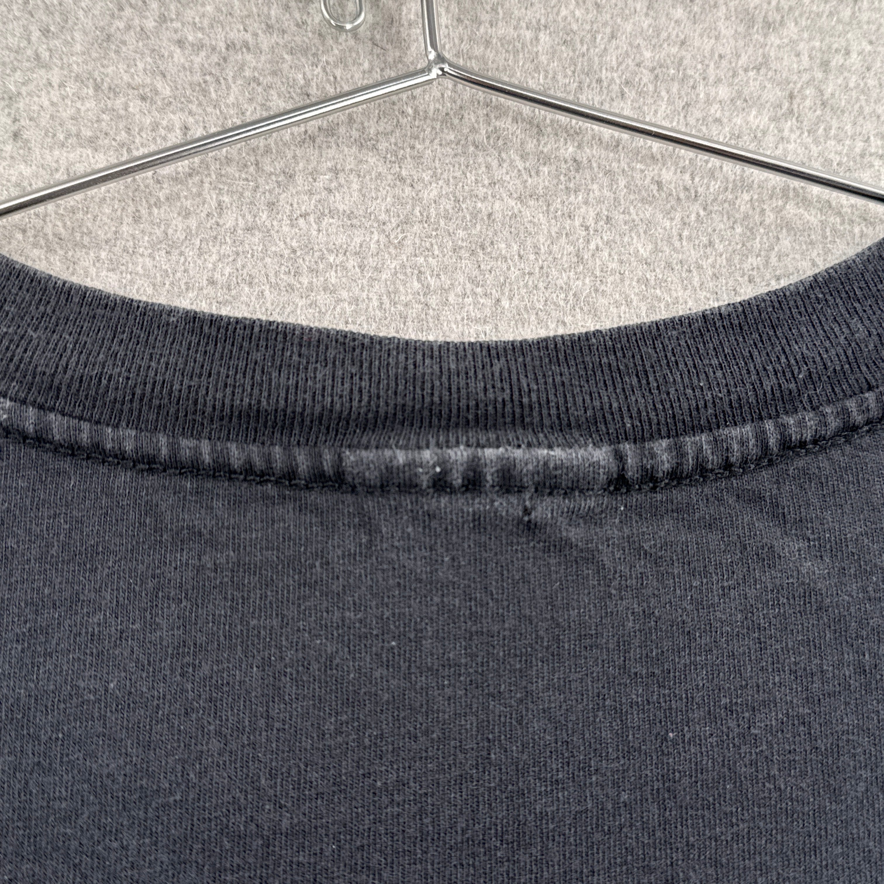 small hole near collar of shirt