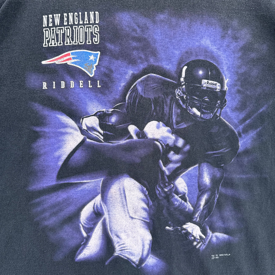 T-shirt with New England Patriots graphic featuring a football player and Riddell logo.