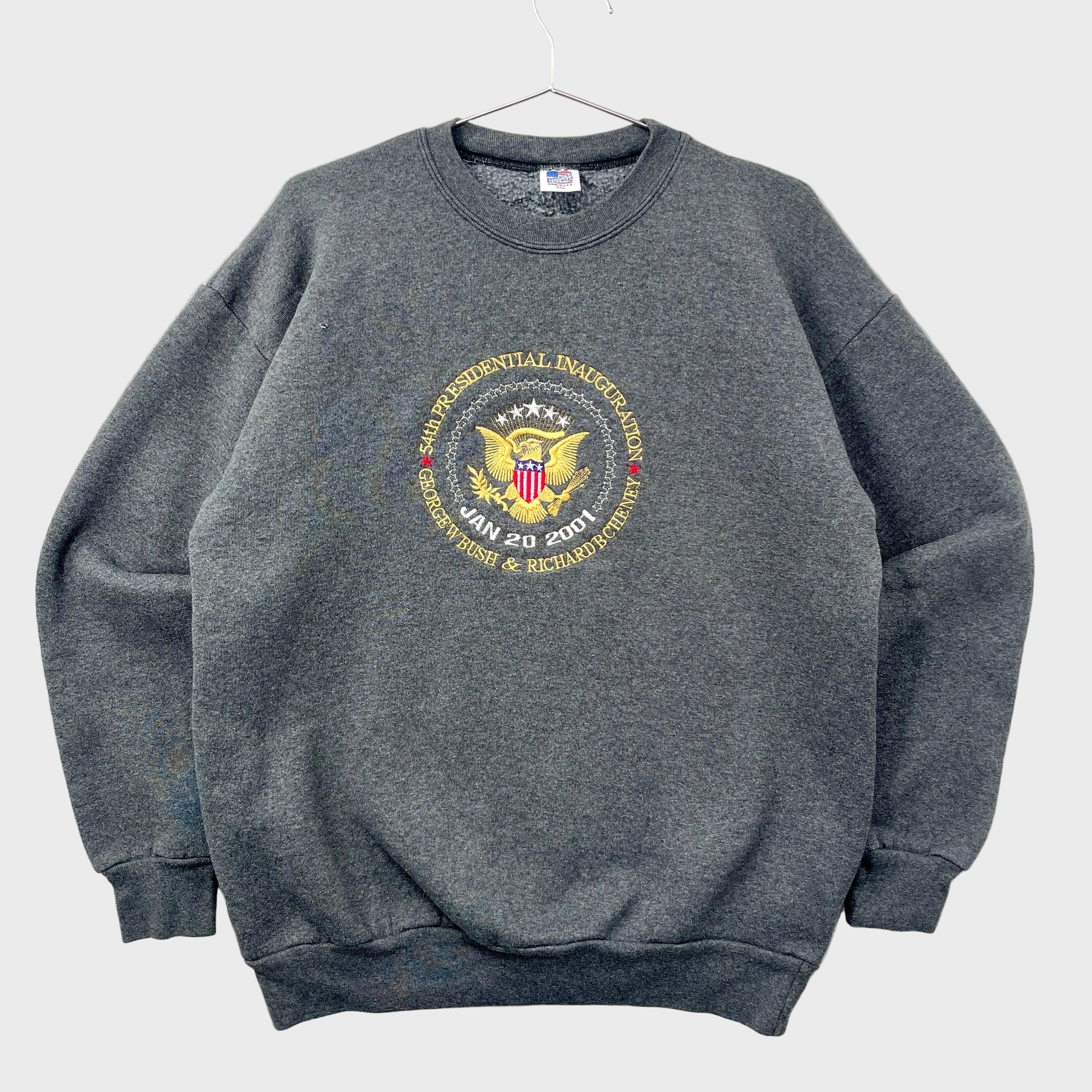 Gray 2001 sweatshirt with a presidential inauguration emblem on a gray background. 54th inauguration on January 20th 2001 for George W Bush and Richard B Cheney.