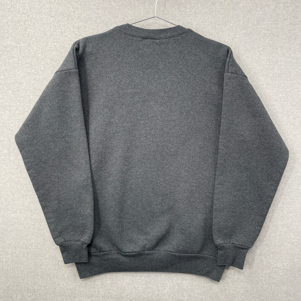Gray sweatshirt folded on a light gray surface. Blank back of sweatshirt