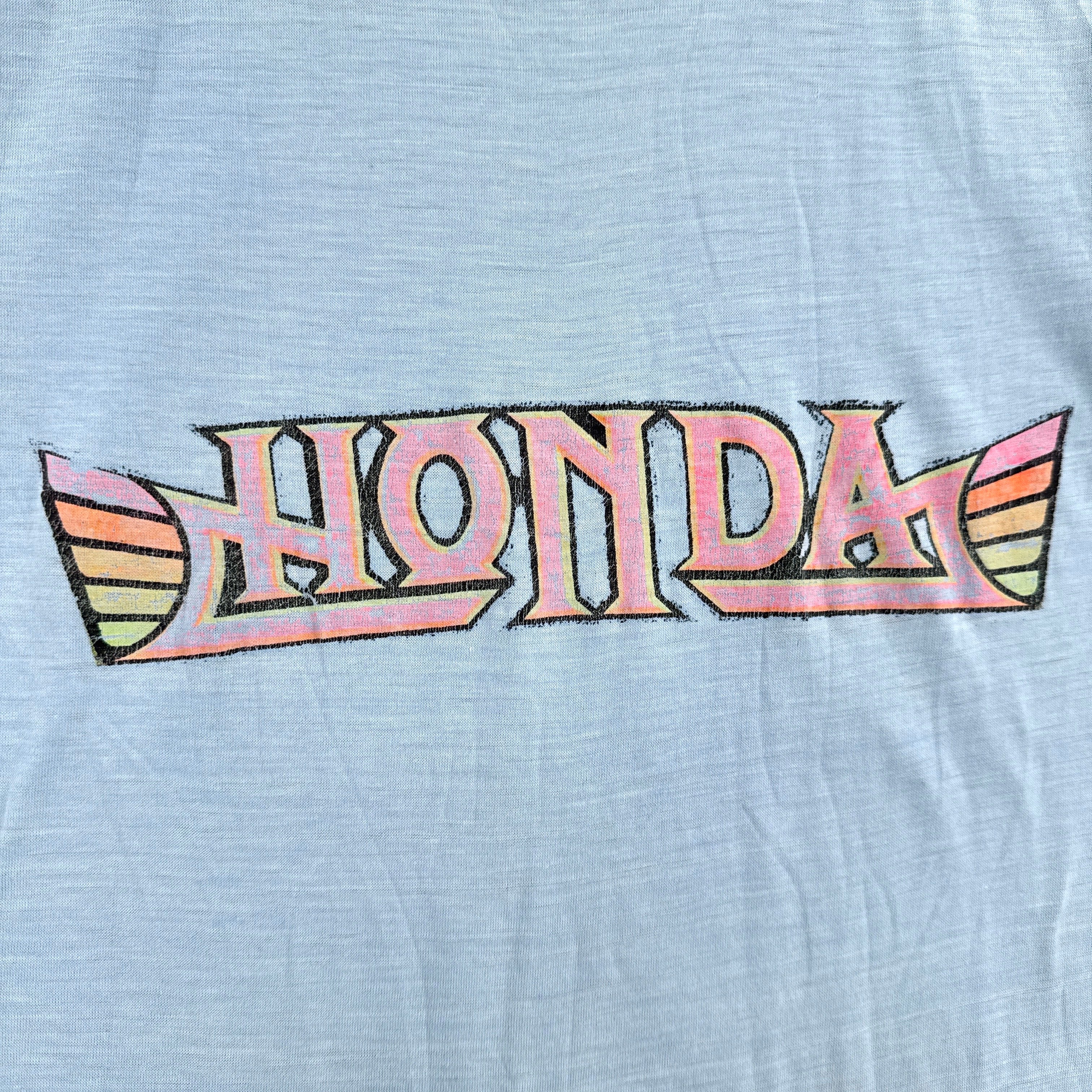 Vintage-style Honda logo on a light blue background