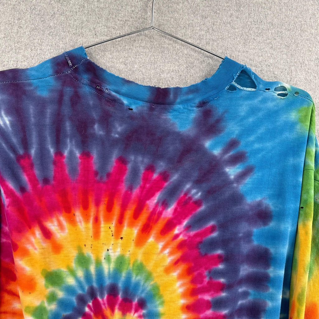 Tie-dye shirt with a colorful spiral pattern on a hanger against a neutral background