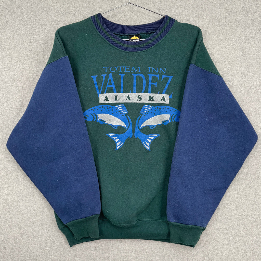 Green and blue sweatshirt with 'Valdez, Alaska' text on a gray background