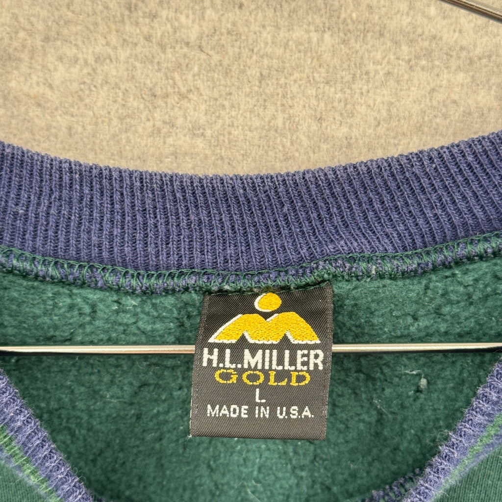 Close-up of a H.L. Miller Gold label on a garment with a textured background. Large made in USA