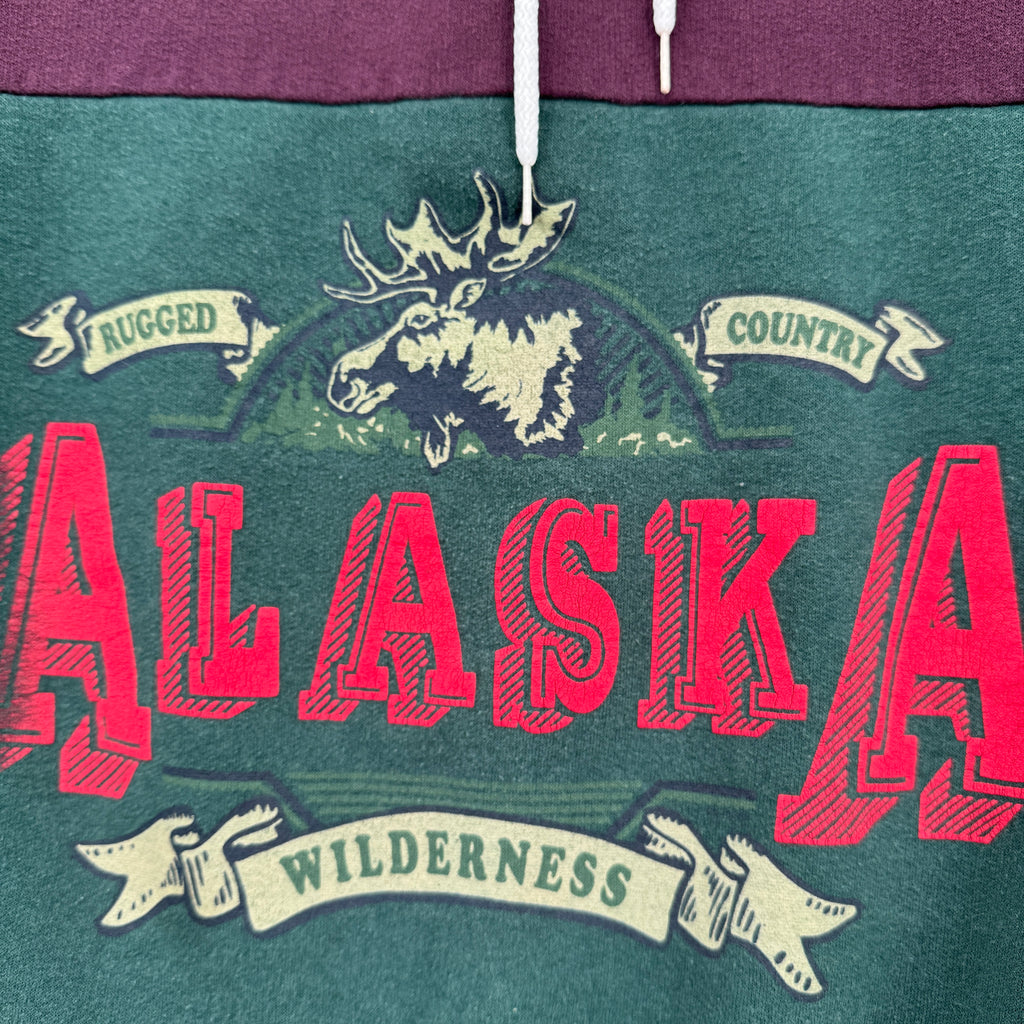 Sweatshirt with 'Alaska' graphic and moose design on a green background