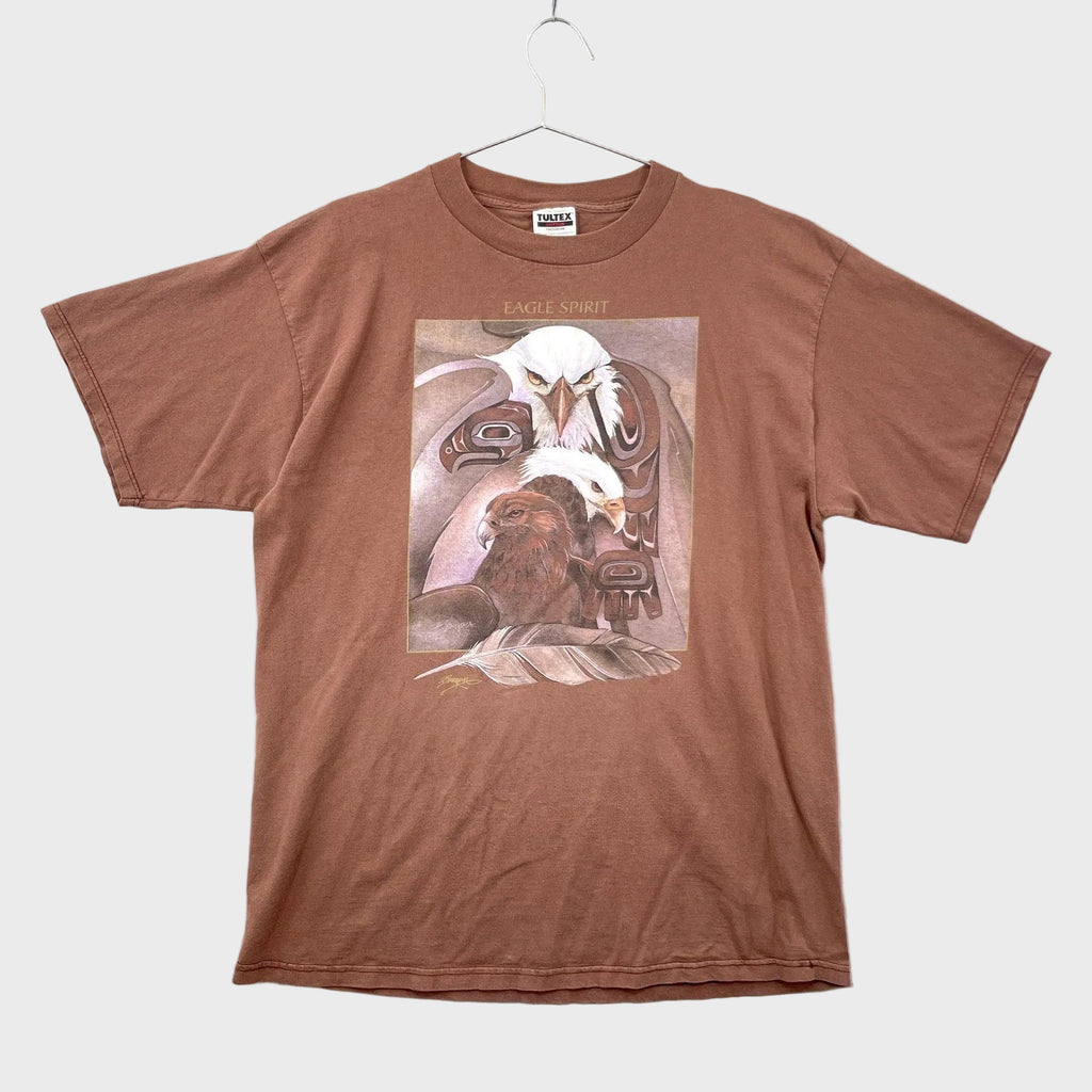 Brown t-shirt with a graphic design of an eagle on a hanger against a light gray background