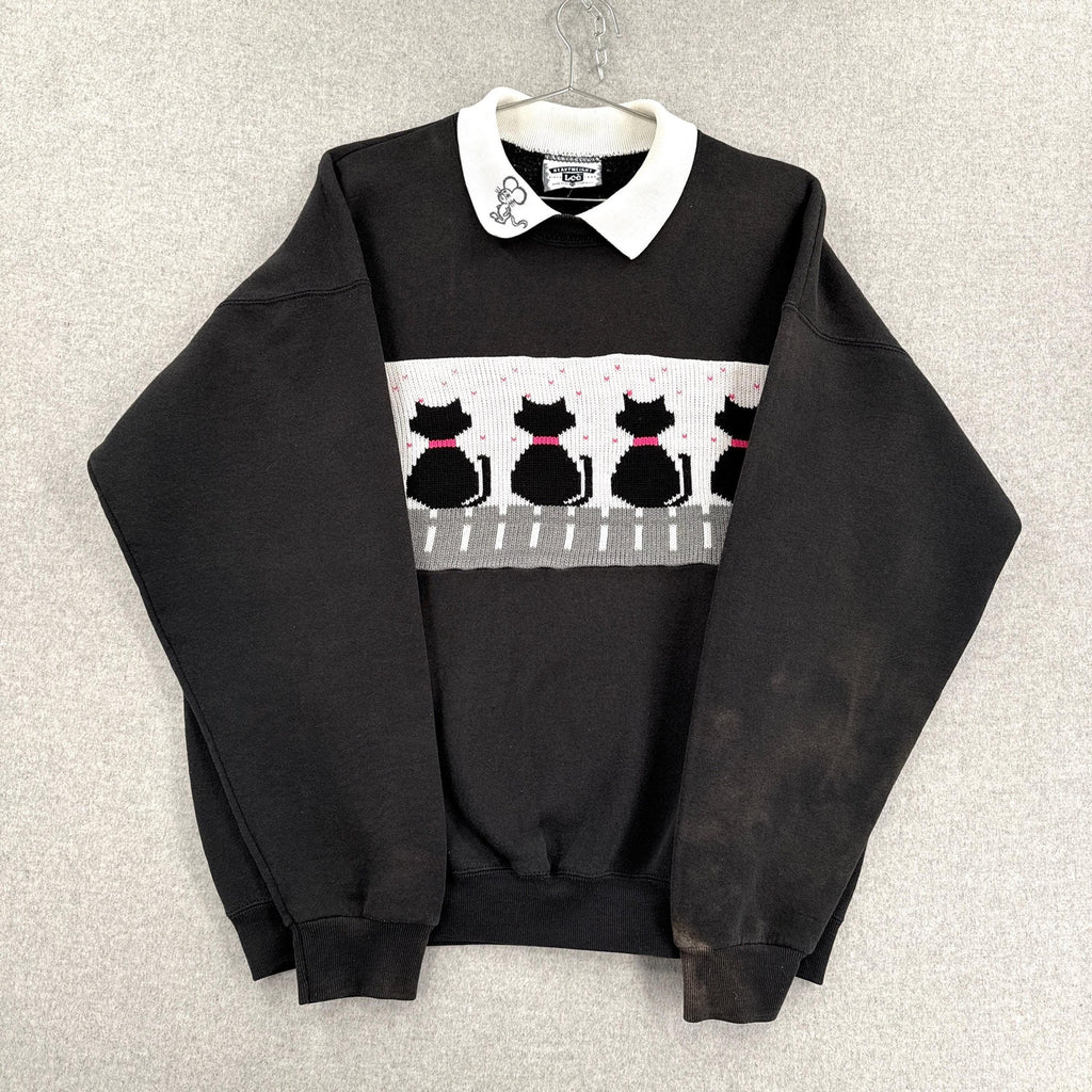 Black sweater with cat pattern on a gray background
