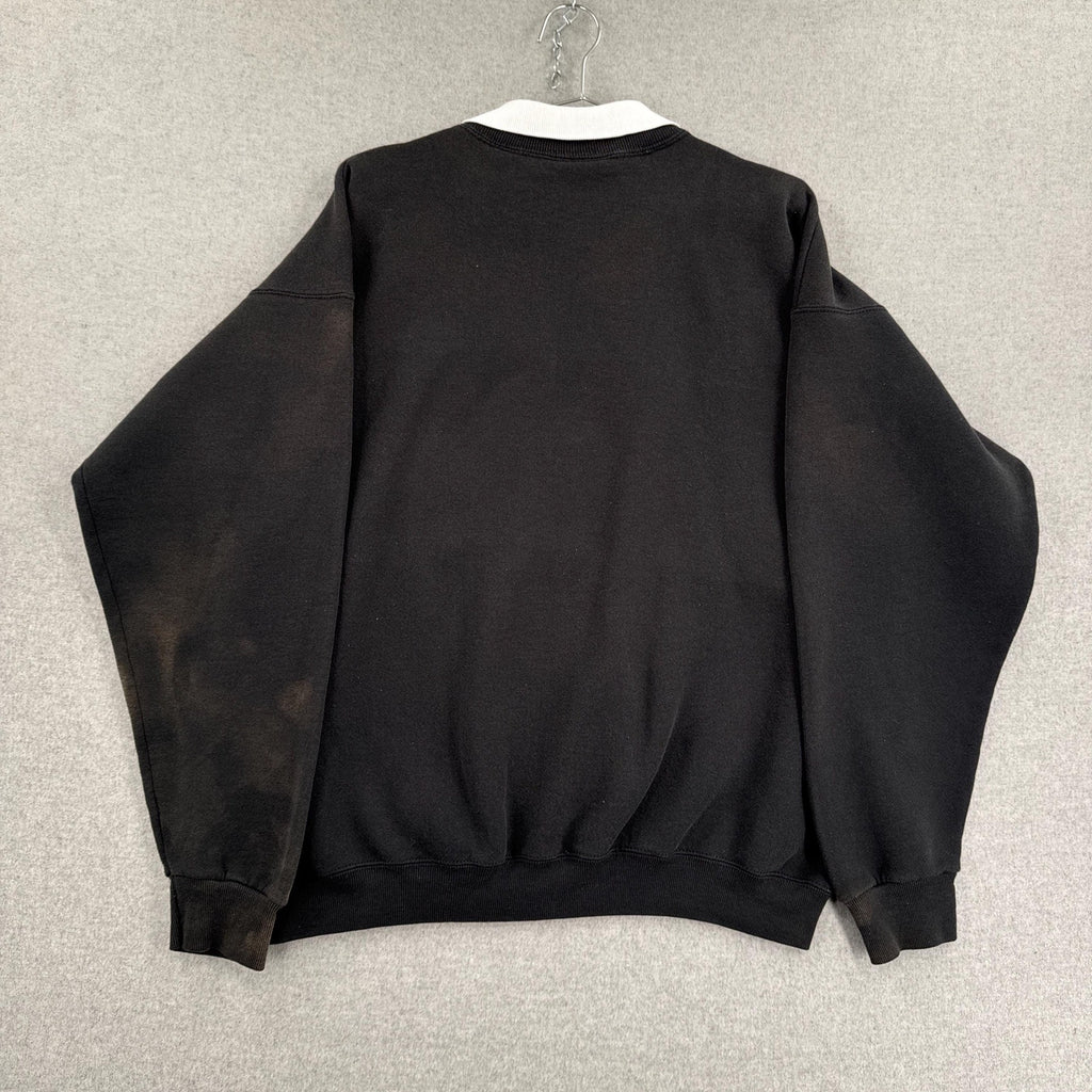 Black sweatshirt on a hanger against a neutral background