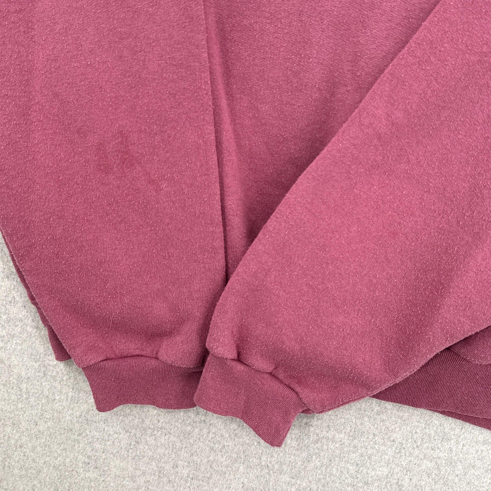 close up of sleeves of sweatshirt with darkened discolouration spots