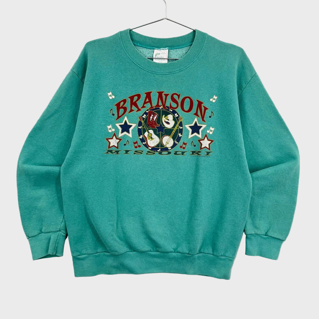 Teal sweatshirt with 'Branson, Missouri' graphic on a gray background