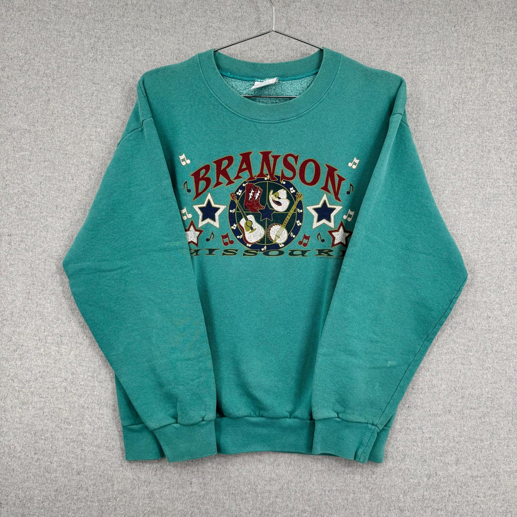 Teal sweatshirt with 'Branson, Missouri' graphic on a gray background