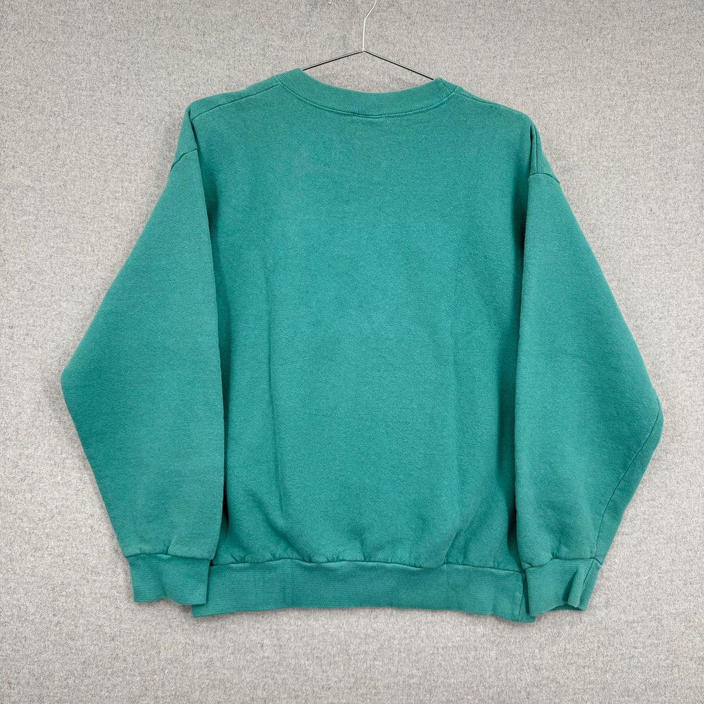 Green sweatshirt on a hanger against a gray background