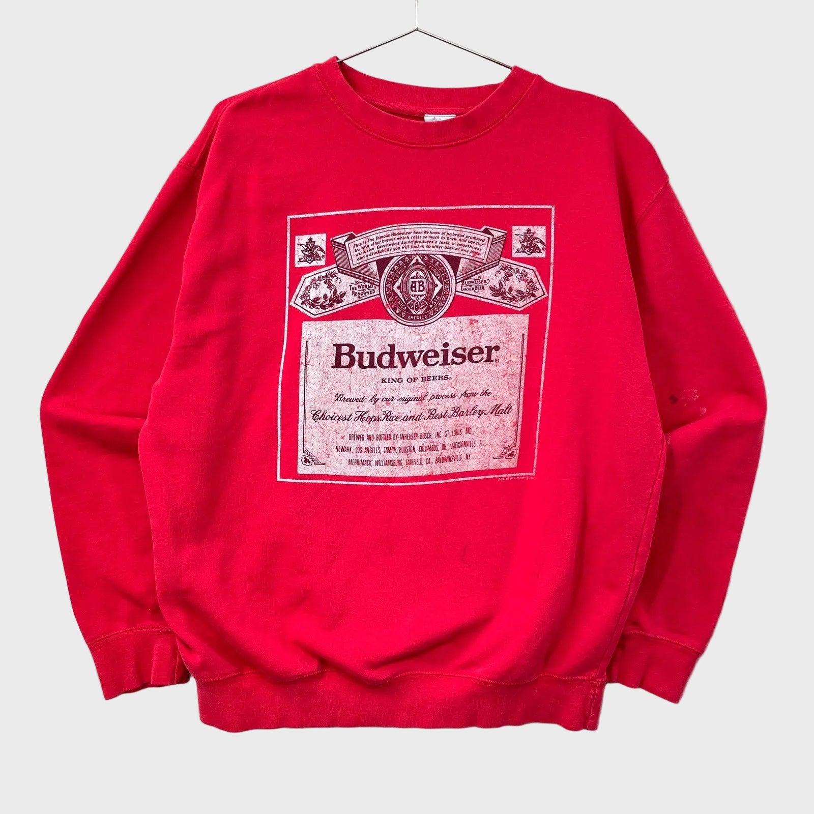 Red sweatshirt with Budweiser logo on a neutral background